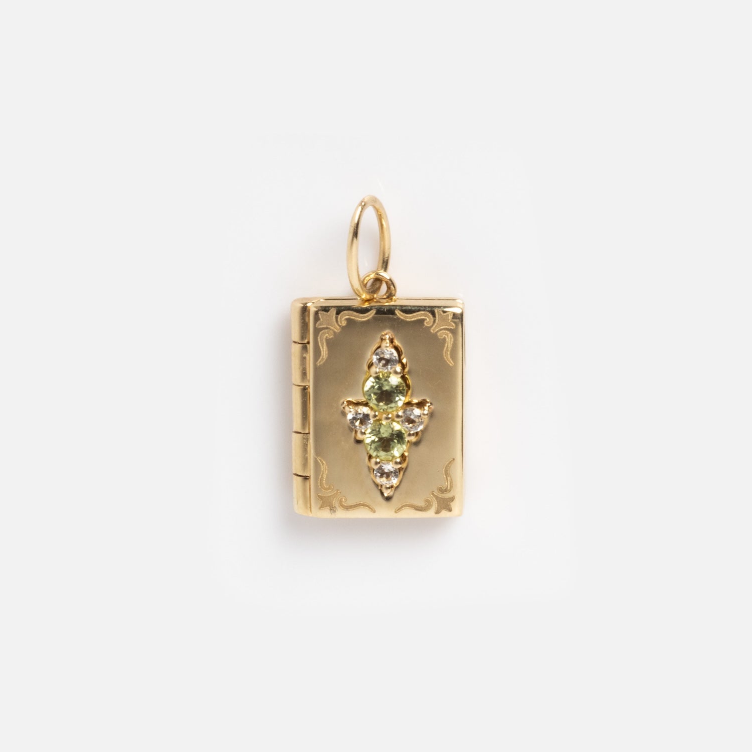The Solid Gold Amulet Charm is a gold book-shaped pendant with ornate detailing and three vertically arranged green gemstones, making a striking gemstone necklace or lucky charm.
