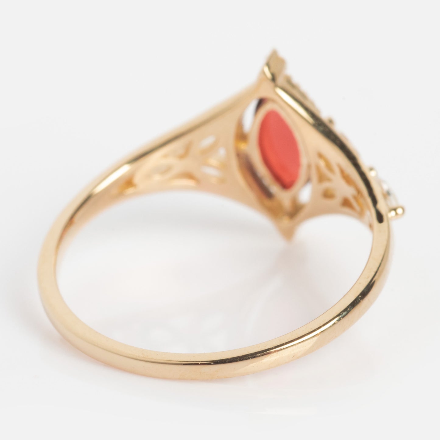 A solid gold Art Deco ring with an intricate band and a stunning oval garnet centerpiece, photographed from the side against a white background. Perfect for those seeking a unique January birthstone style: the 2026 January Capsule Garnet Ring.