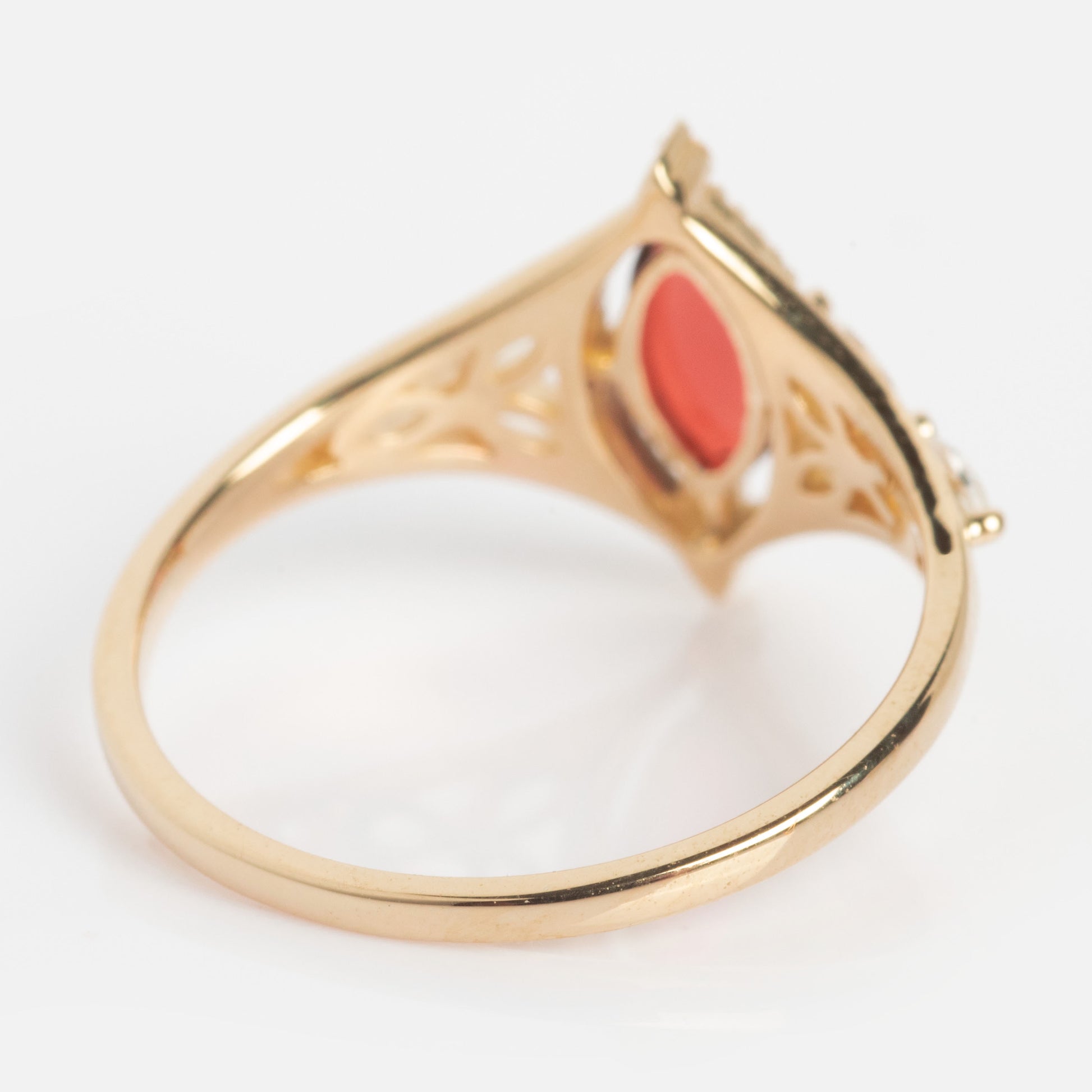 A solid gold Art Deco ring with an intricate band and a stunning oval garnet centerpiece, photographed from the side against a white background. Perfect for those seeking a unique January birthstone style: the 2026 January Capsule Garnet Ring.