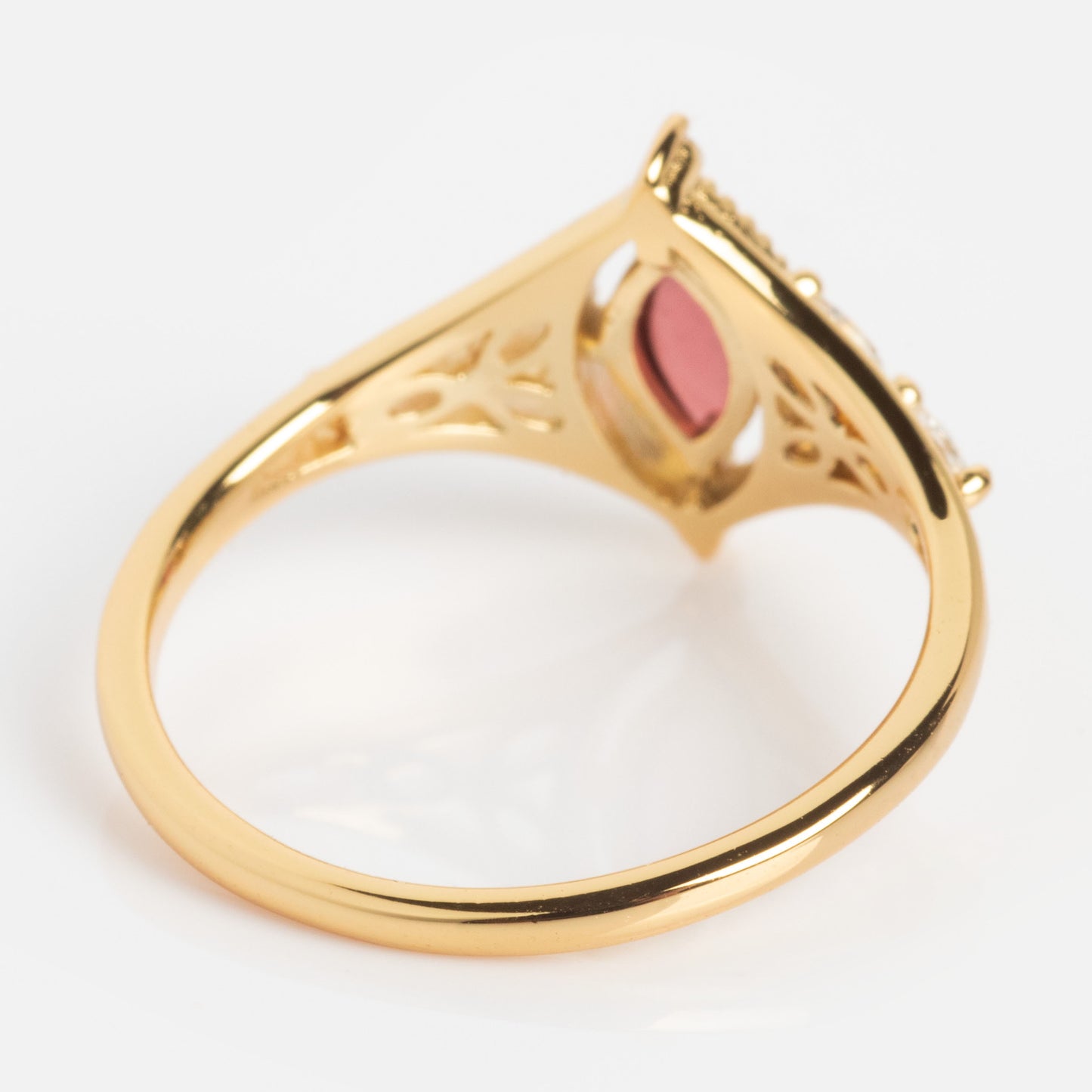 The 2026 January Capsule Art Deco Garnet Ring features a vintage-inspired yellow gold vermeil openwork band and a marquise-shaped garnet at the center, shown from the side on a white background.