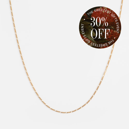 The Solid Gold Figaro Chain, made from 9k yellow gold, is shown on a white background with a circular sticker that says “The Sweetest Gifts Event, 30% Off” in white and red—an ideal addition to your necklace stack.