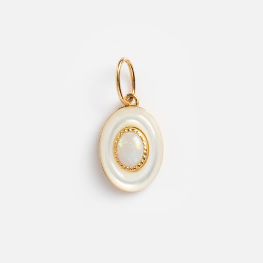A round solid gold pendant features a central pink opal, bordered by a white enamel ring and gold rim, attached to a gold jump ring. Product: Solid Gold Modern Pink Opal Charm Sample. Displayed against a plain white background.