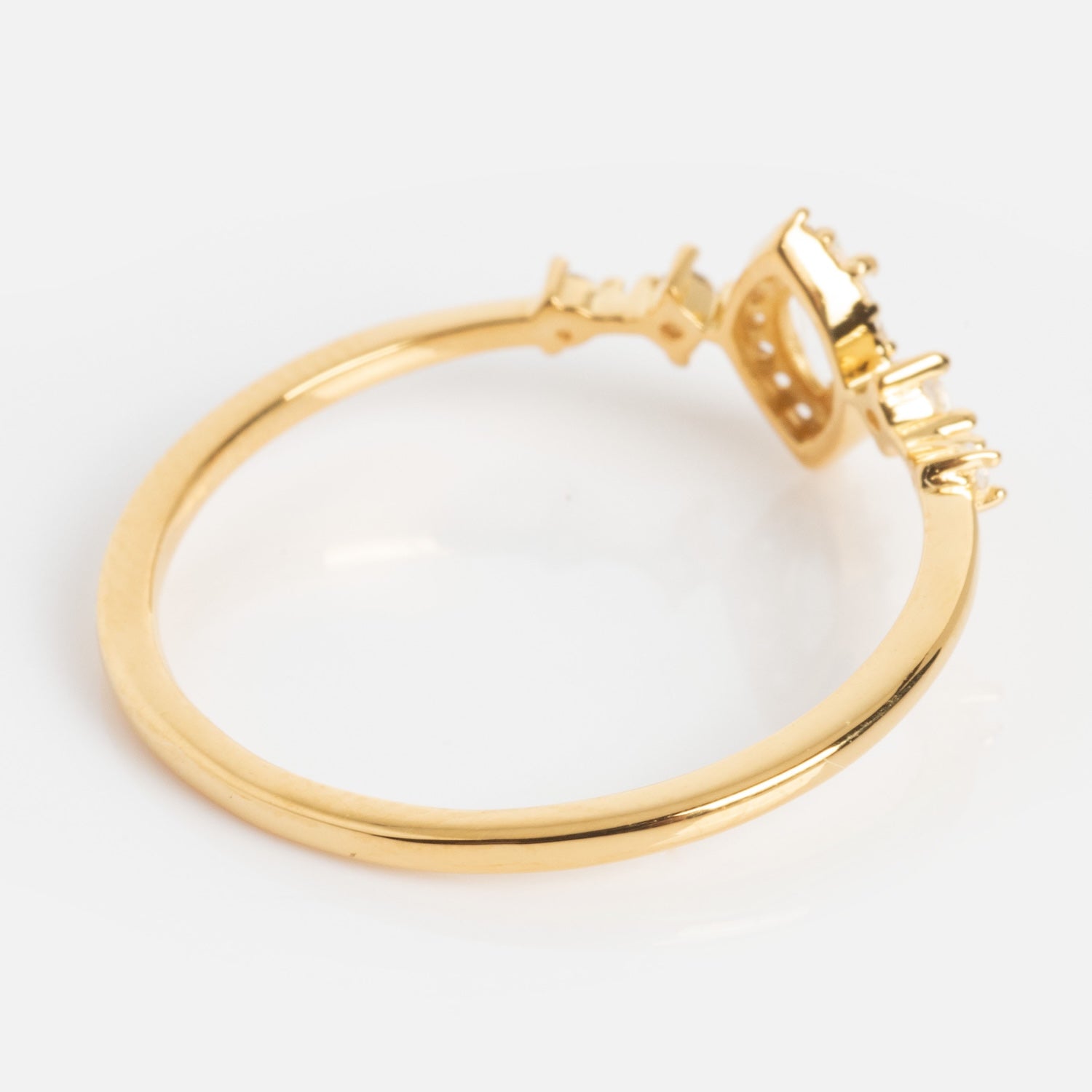 The White Topaz Harlow Ring showcases a thin 18k gold vermeil band and a striking geometric marquise setting, elegantly displayed against a white background.