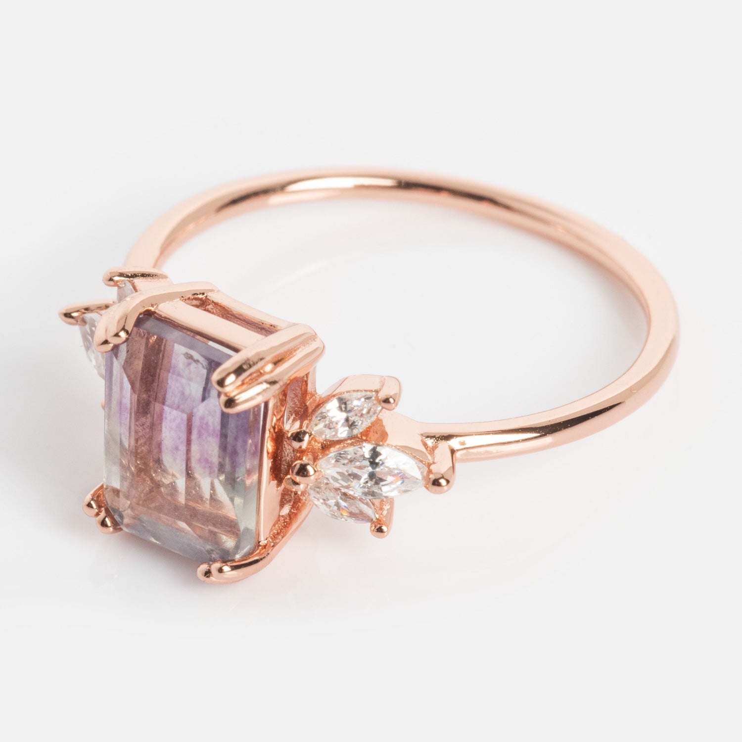 Exclusive to Local Eclectic, the Rose Gold Fluorite Topaz Hazy Dream Ring showcases a rectangular purple and brown fluorite stone with two marquise-cut clear accents in rose gold vermeil.