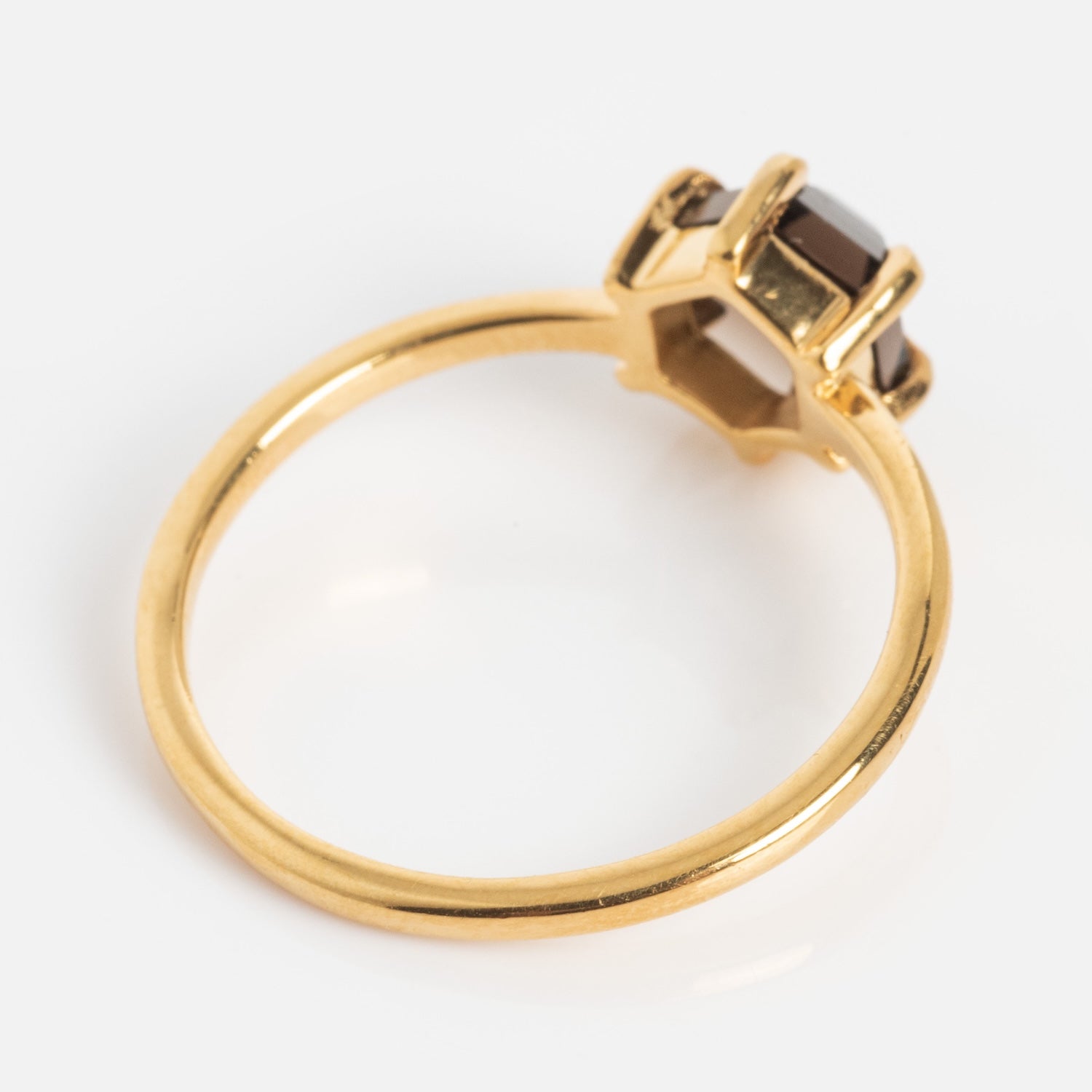 The Hexagon Smokey Quartz Ring features a gold band with a single dark, hexagon-shaped gemstone in a prong setting, showcased on a plain white background.