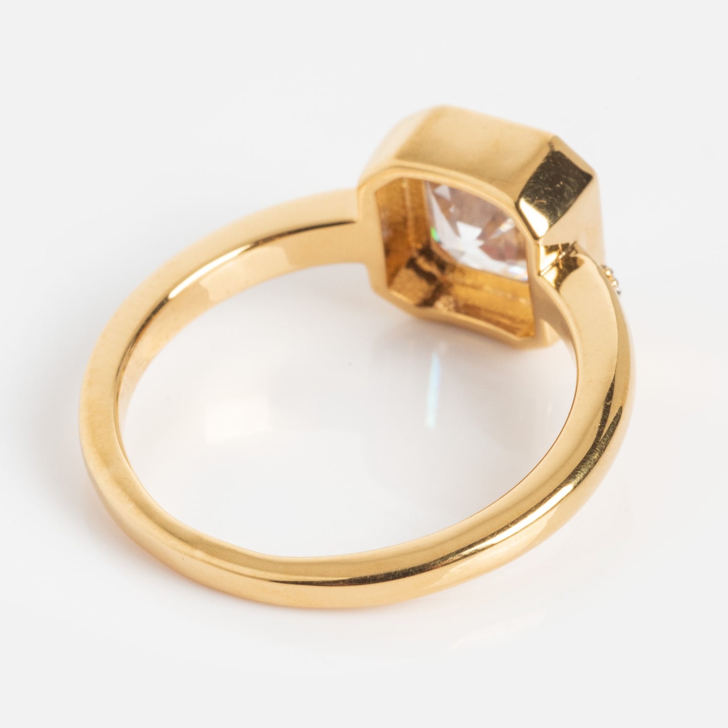 The White Topaz Statement Star Set Band is a gold ring featuring a prominent clear gemstone in a square bezel setting, shown against a white background.