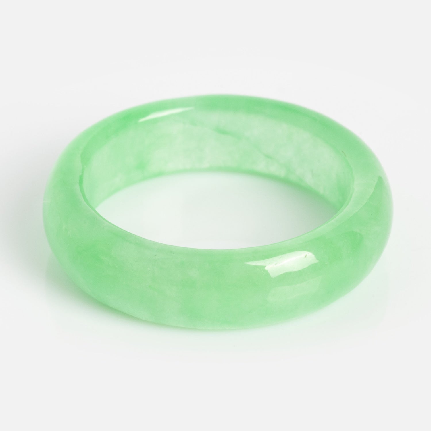 The ZZ Imperial Green Jade Ring features a glossy, translucent light green jade with a smooth, rounded finish and a 5 mm band width, shown on a plain white background.