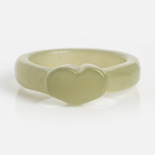 The Heart Jade Ring is a pale green, chunky resin ring with a raised heart at the center and a 3.5 mm band, shown on a white background.