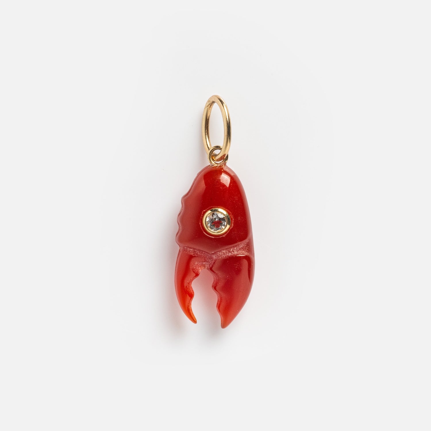The Solid Gold Under The Sea Charm features a small red lobster claw with a clear gemstone center on a gold keyring, perfect for nautical jewelry lovers. Photographed against a plain white background.
