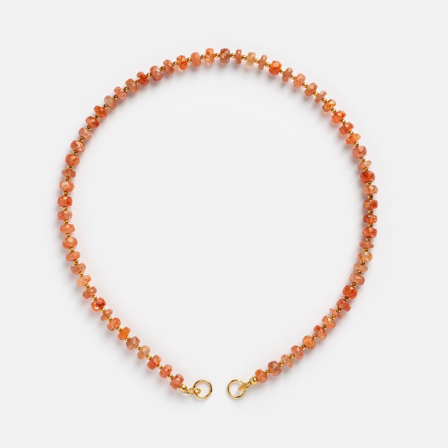 The Customizable Beaded Gemstone Charm Holder Necklace features round, faceted orange and gold beads with a gold hook clasp, arranged in a circle on a white background.