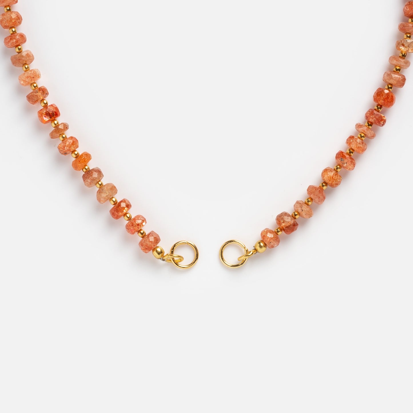 A close-up of the Customizable Beaded Gemstone Charm Holder Necklace with orange and gold beads and gold lobster claw clasps, shown on a white background.
