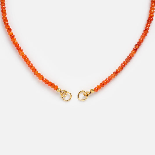 A close-up of the Customizable Beaded Gemstone Charm Holder Necklace featuring small faceted orange beads and gold clasps, displayed on a white background.