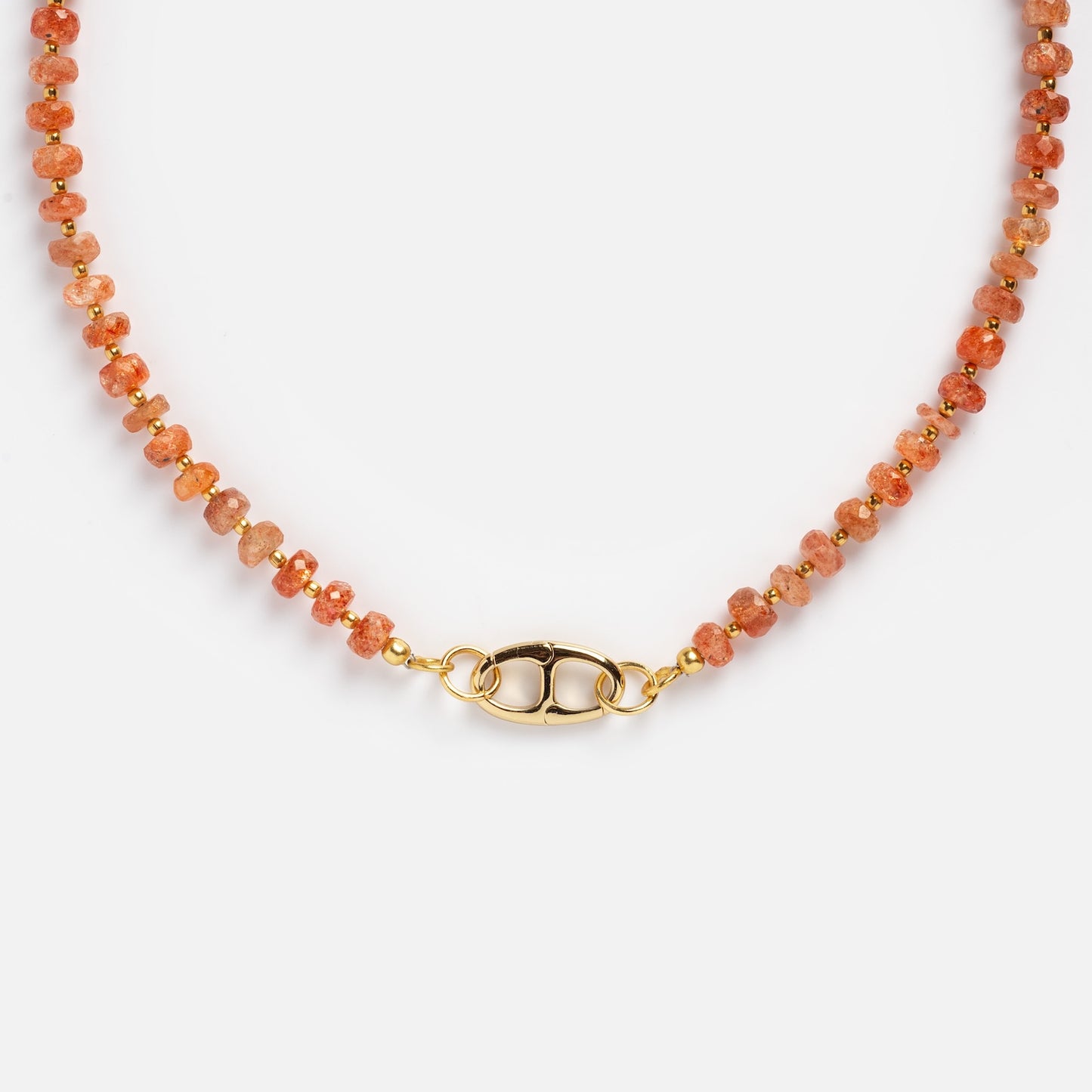 A close-up of the Customizable Beaded Gemstone Charm Holder Necklace, featuring small faceted orange stones, gold spacer beads, and a gold oval clasp, displayed on a white background.
