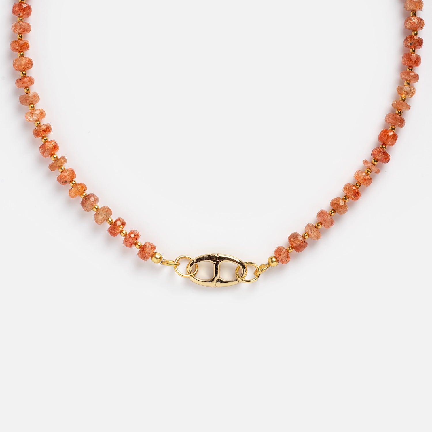 A close-up of the Customizable Beaded Gemstone Charm Holder Necklace, featuring small faceted orange stones, gold spacer beads, and a gold oval clasp, displayed on a white background.
