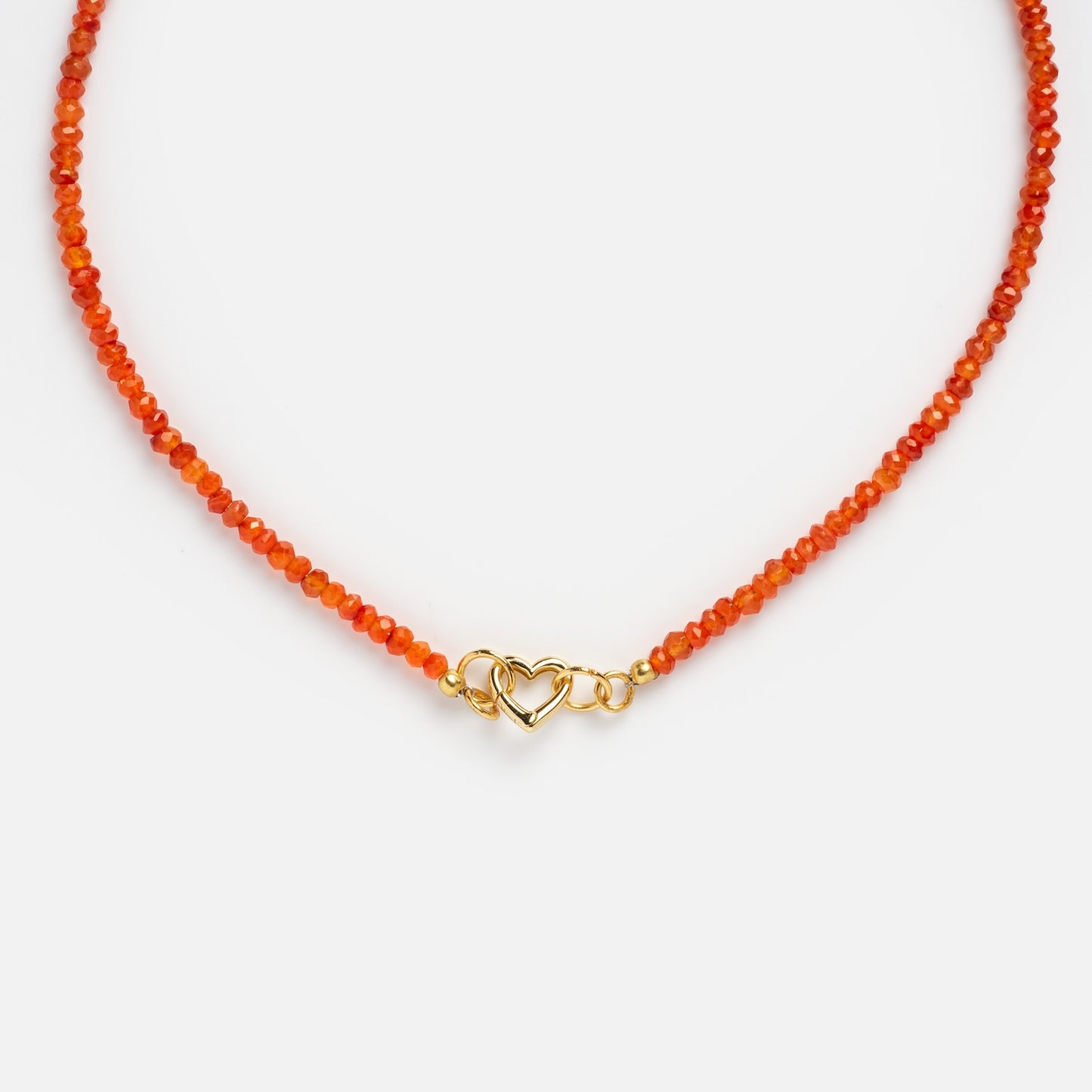The Customizable Beaded Gemstone Charm Holder Necklace features delicate orange beads and a gold clasp with an intertwined double heart design, displayed on a white background.