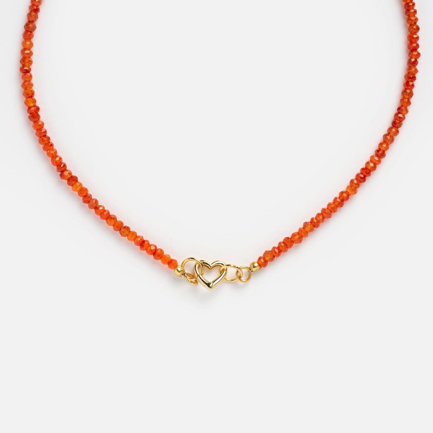 The Customizable Beaded Gemstone Charm Holder Necklace features delicate orange beads and a gold clasp with an intertwined double heart design, displayed on a white background.