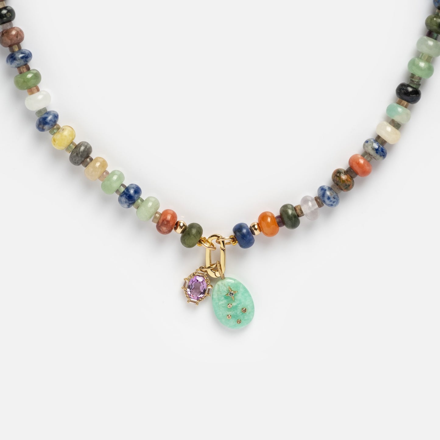 The Macey Customizable Beaded Charm Holder Necklace features multicolored round beads, a mint green oval charm with star accents, and a small lavender stone set in gold.