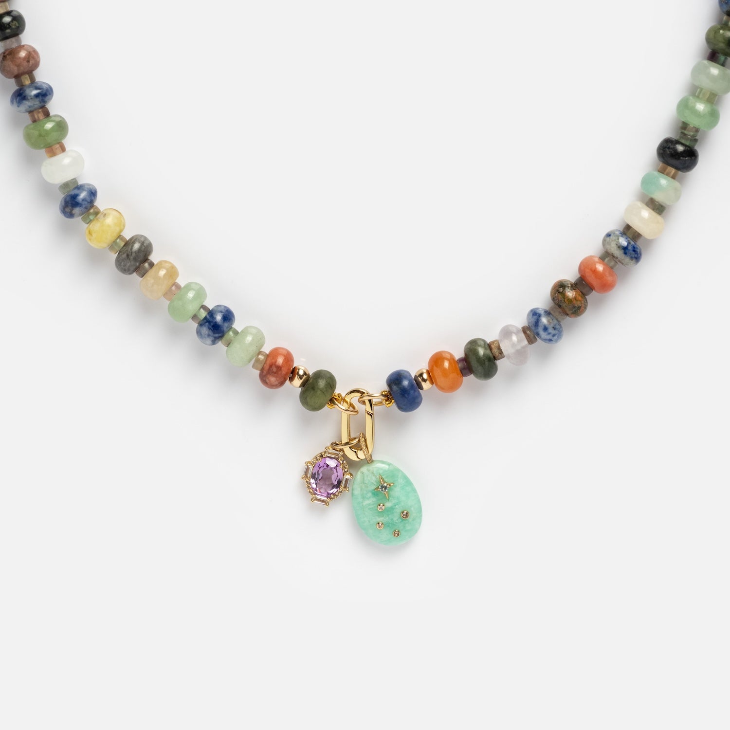 The Macey Customizable Beaded Charm Holder Necklace features multicolored round beads, a mint green oval charm with star accents, and a small lavender stone set in gold.