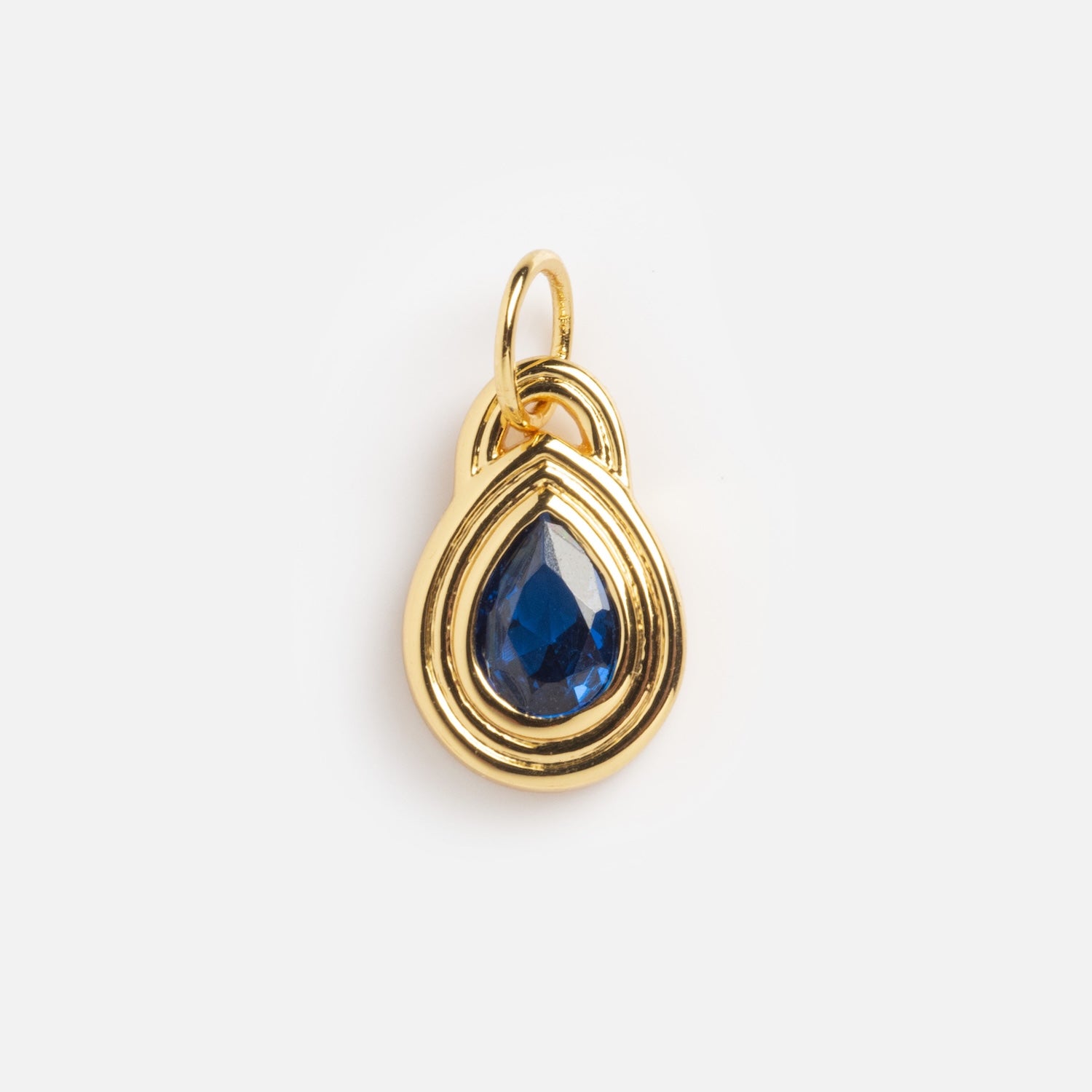 Monroe Birthstone Charm: gold teardrop-shaped pendant featuring a blue gemstone at its center, shown on a plain white background.