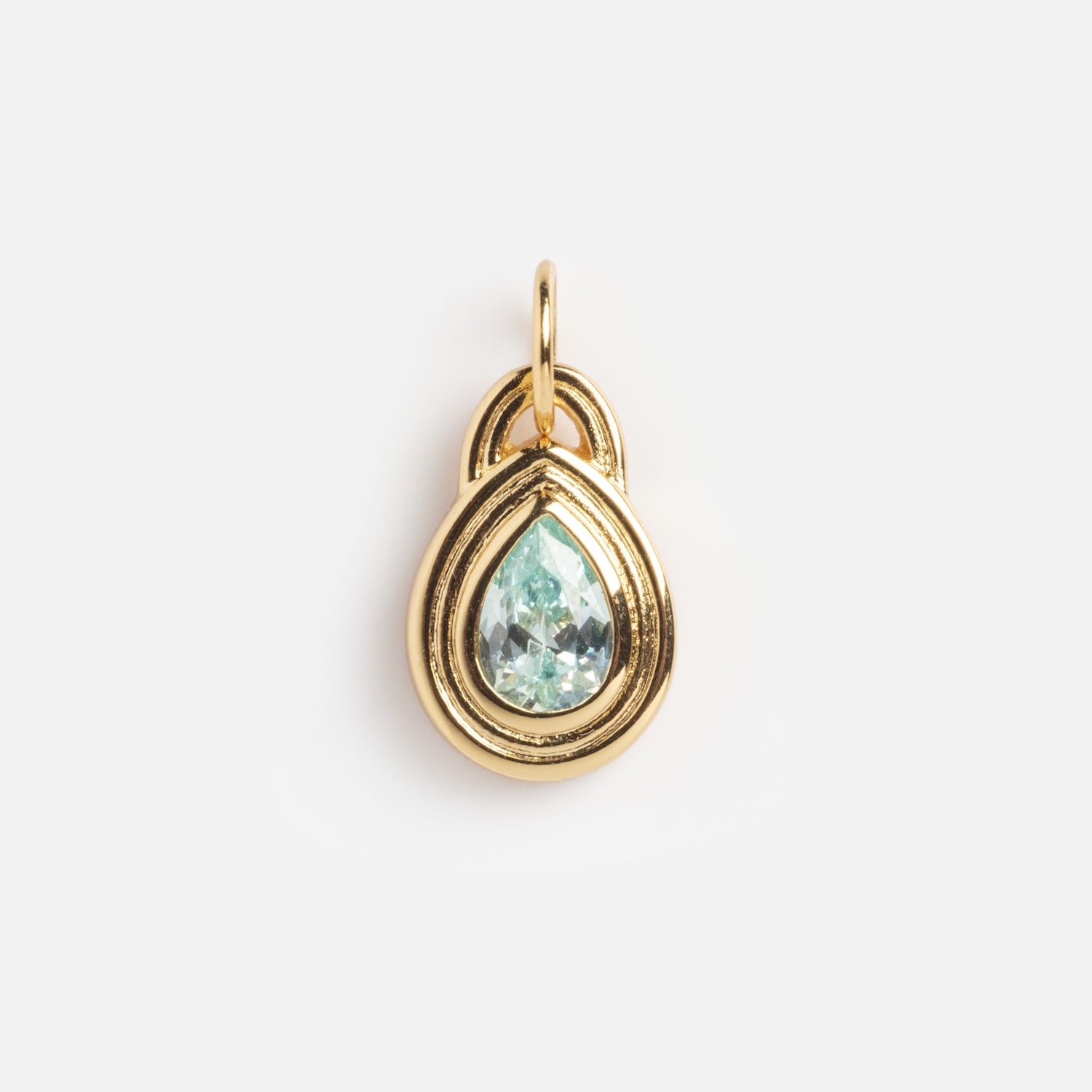 The Monroe Birthstone Charm is a gold pendant with a teardrop-shaped light blue gemstone at its center, a smooth gold border, and a top loop for attaching to a chain, displayed on a plain white background.