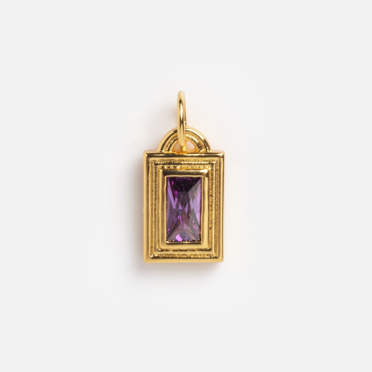 The Monroe Birthstone Charm is a rectangular gold pendant featuring a central purple gemstone and a top loop for attaching to a chain, shown against a plain white background.