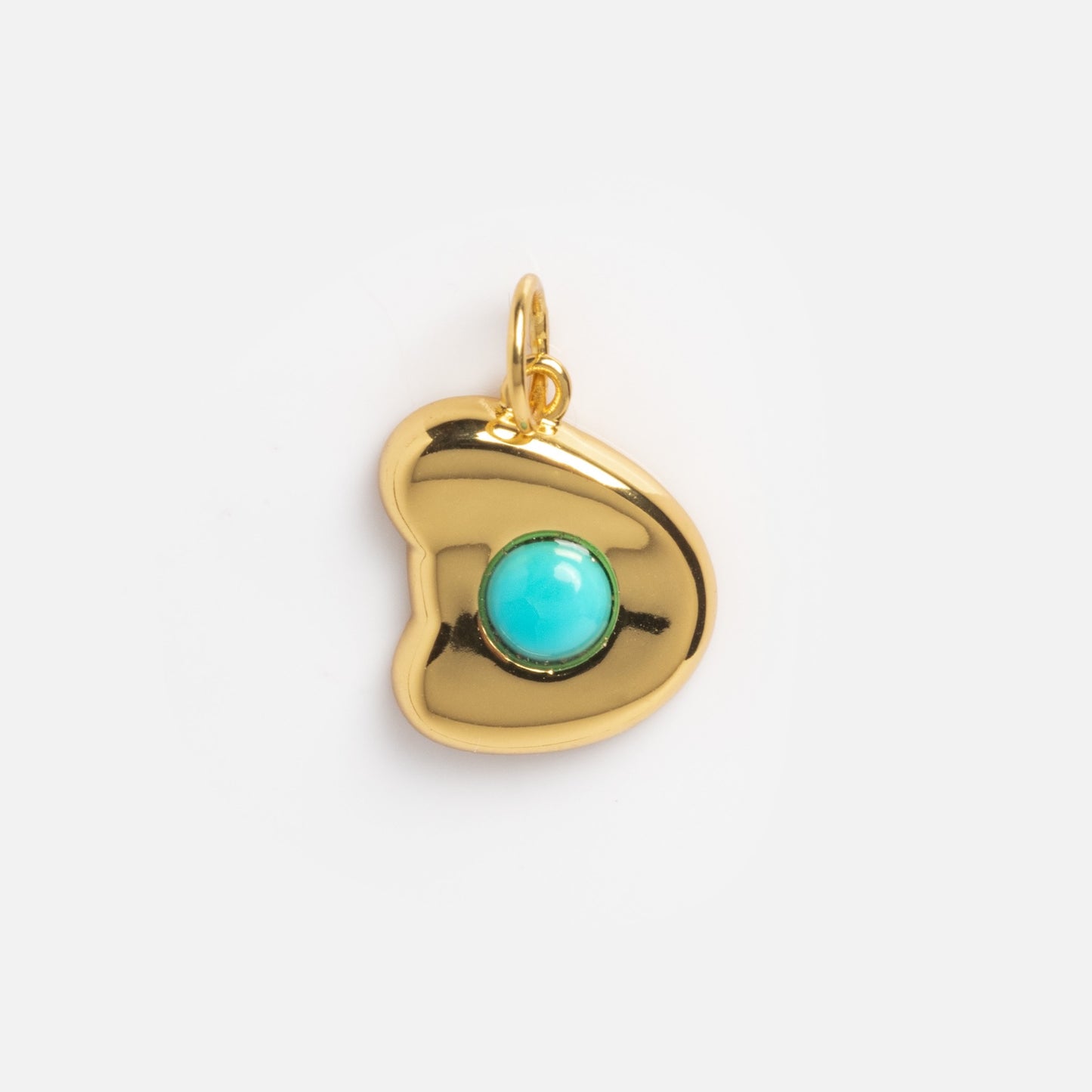 The Thea Bubble Letter Charm is a gold heart-shaped pendant with a smooth, shiny finish and a round turquoise stone at its center, displayed against a plain white background.