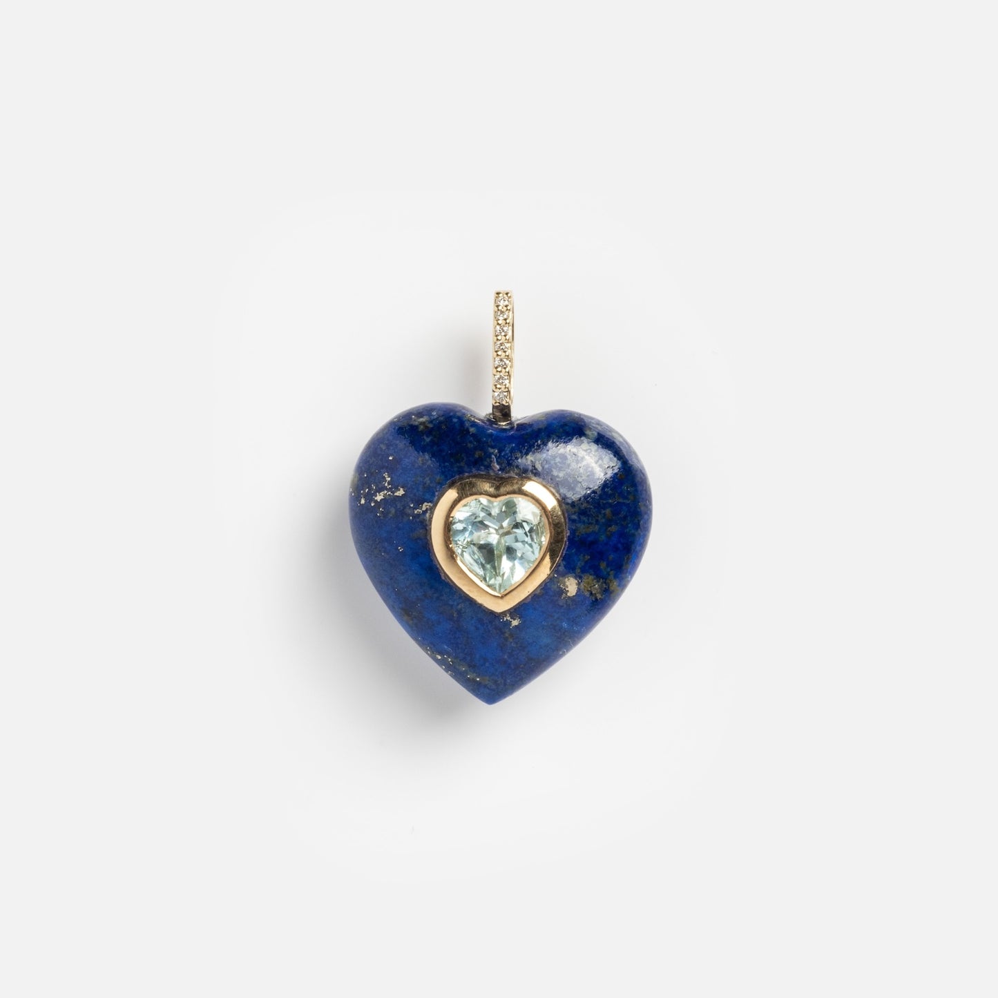 A blue heart-shaped 14k Lapis Lazuli and Blue Topaz Heart Pendant Charm with a gold frame and diamond-accented bail shines against a plain white background.