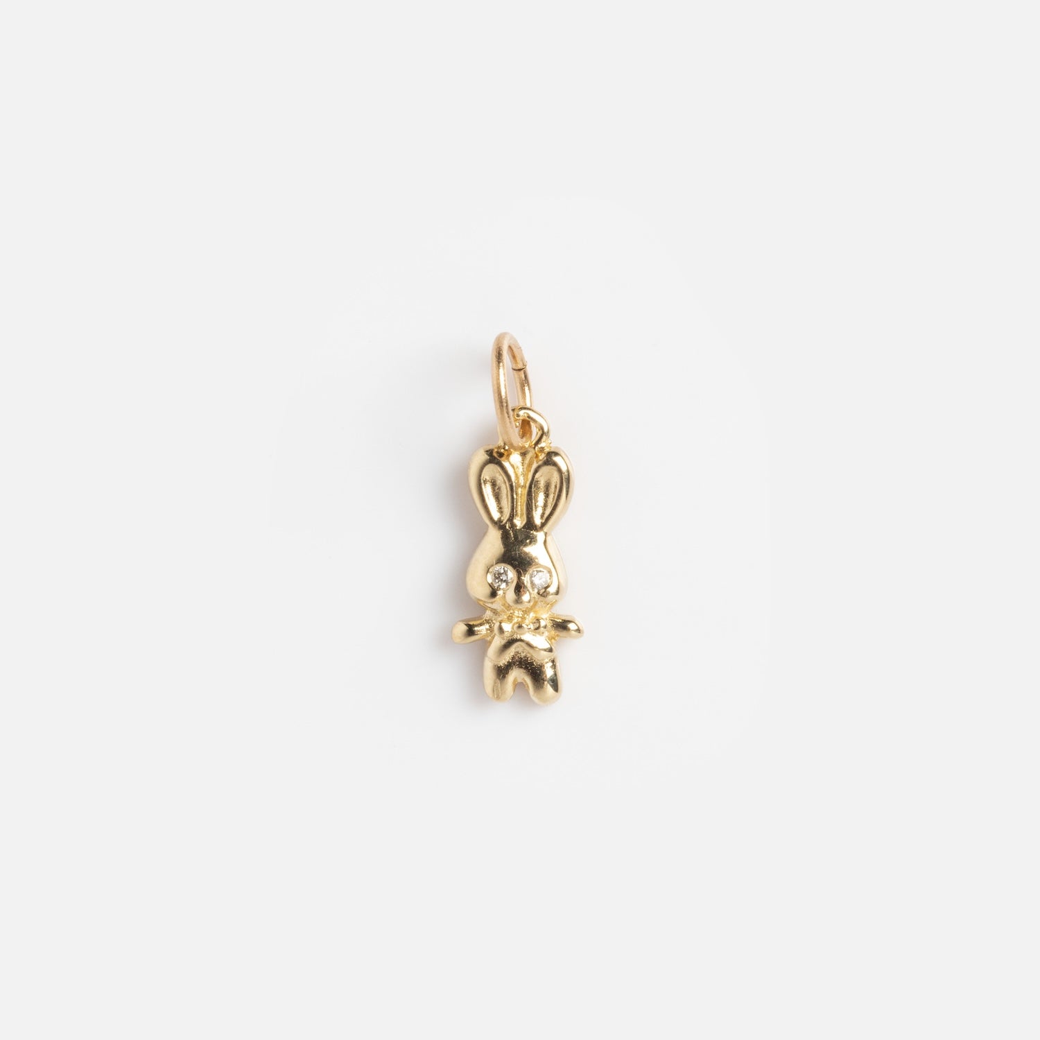 Charms by Charlie and Marcelle: A shiny gold bunny charm with long ears and a top loop for attaching to necklaces or bracelets, shown on a plain white background.