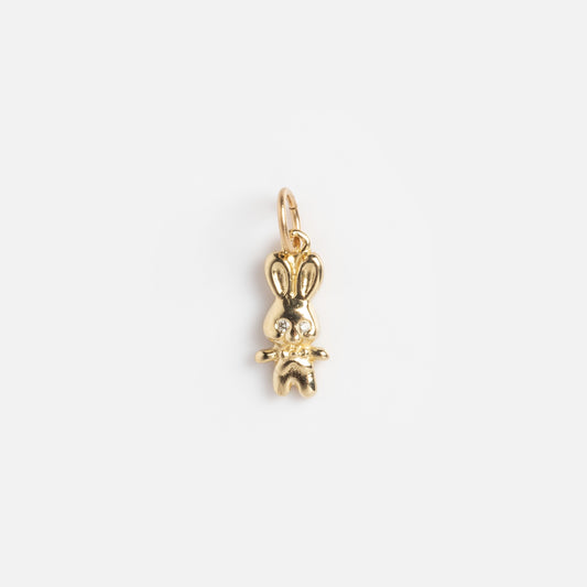 Charms by Charlie and Marcelle: A shiny gold bunny charm with long ears and a top loop for attaching to necklaces or bracelets, shown on a plain white background.