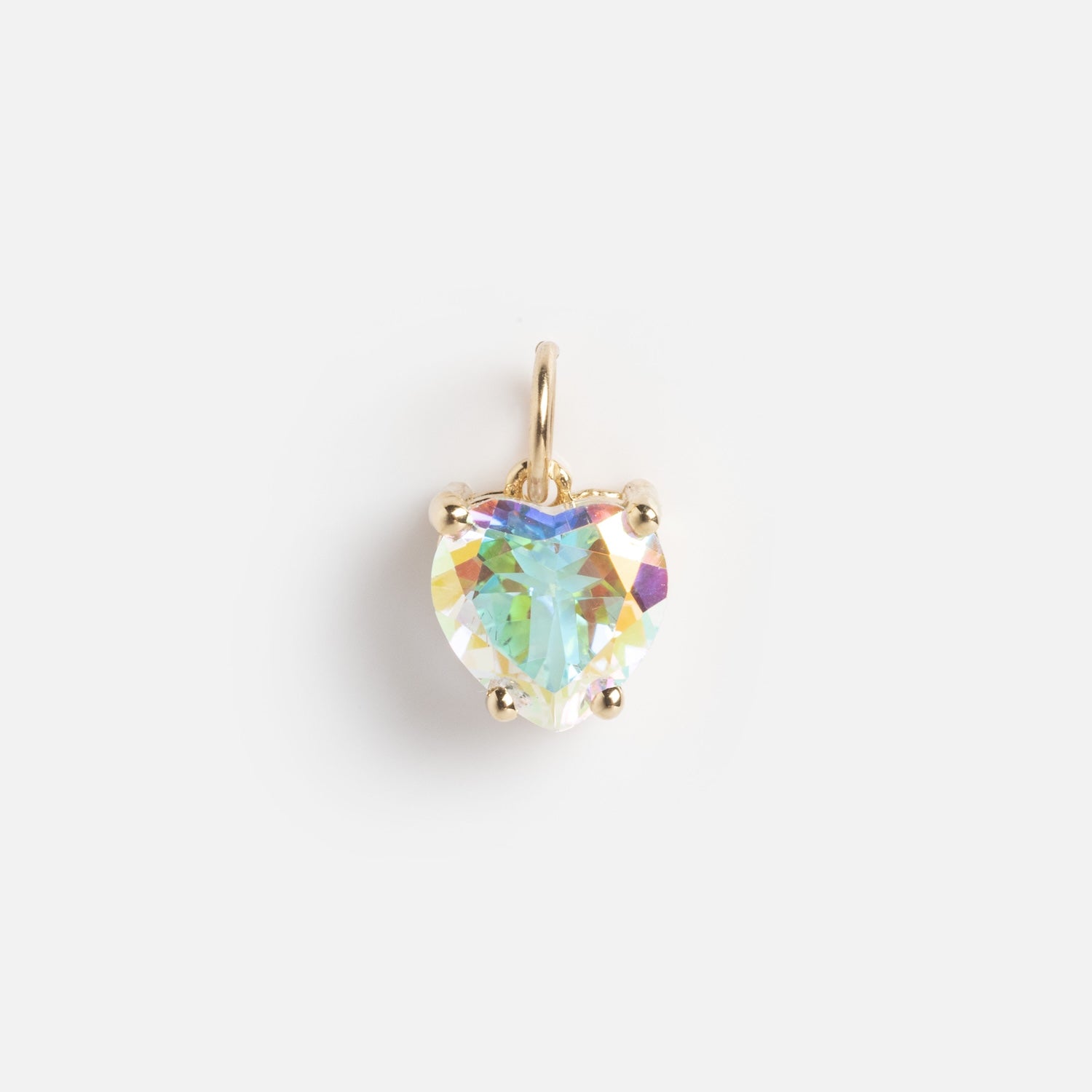 The Charms by Charlie and Marcelle gold pendant features a heart-shaped, iridescent gemstone set in prongs, shown on a plain white background.