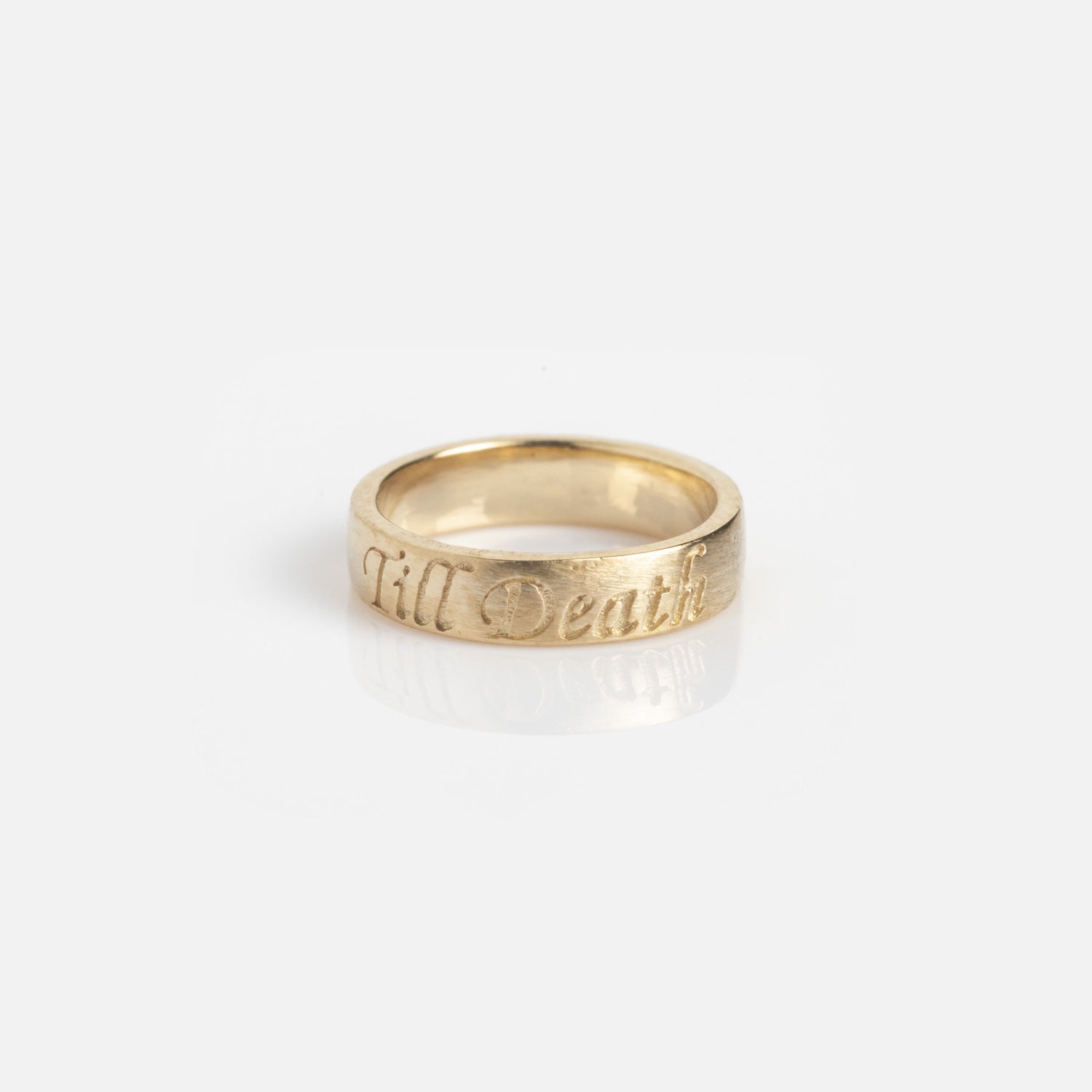 Charms by Charlie and Marcelle gold ring features the engraving "Till Death" on its outer surface, shown against a plain white background.