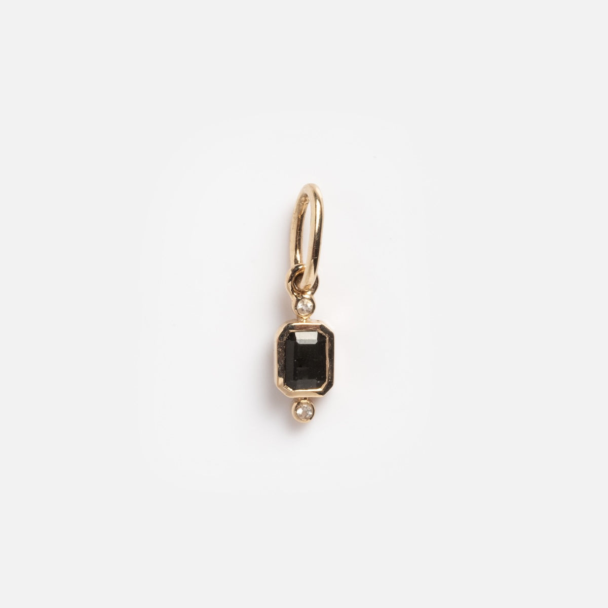 A Solid Gold Delicate Moonstone Drop Charm is shown against a plain white background, featuring a rectangular moonstone at the center with small round gems above and below.