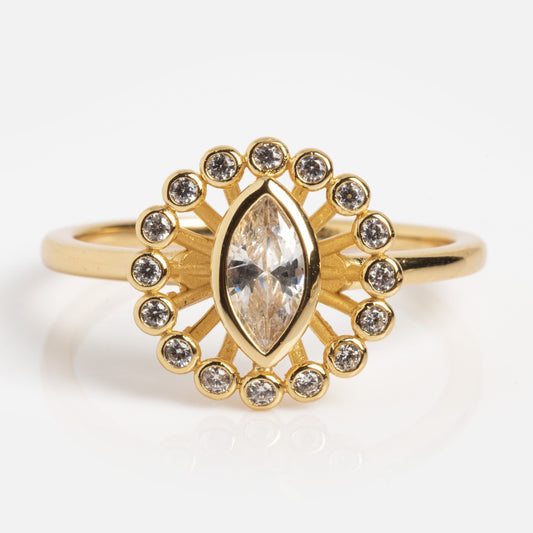 The Vintage Inspired White Topaz Halo Ring (Sample Size 7) features a central marquise-cut white topaz, encircled by a halo of smaller stones in a sunburst design on a classic gold band.