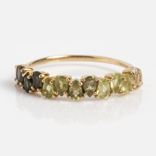 The Solid Gold Ombre Birthstone Ring August Sample Size 4 showcases a row of oval gemstones, blending from dark green to light yellow-green tones.