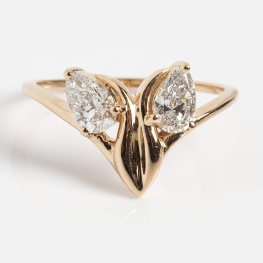 The Solid Gold Twisted Arch Diamond Ring (Sample Size 7) is crafted in 14k yellow gold, showcasing two 6mm pear-shaped lab diamonds set side by side with their points facing down for a bold, modern look.