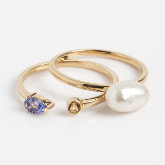 The Solid Gold Topaz Tanzanite and Pearl Stacked Ring (Sample Size 7) features minimalist, modern 9k yellow gold bands with tanzanite, yellow topaz accent, and a large white pearl, shown on a white background.