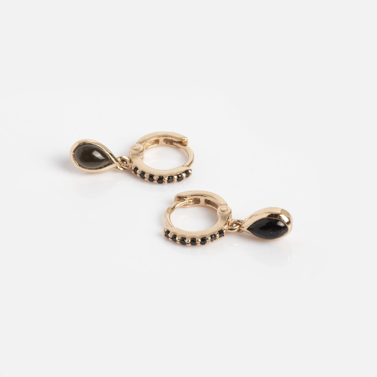 The Solid Gold Black Obsidian Huggie Hoop Earrings Sample features 9k gold hoops with black obsidian teardrop pendants and small black stones, shown on a plain white background.