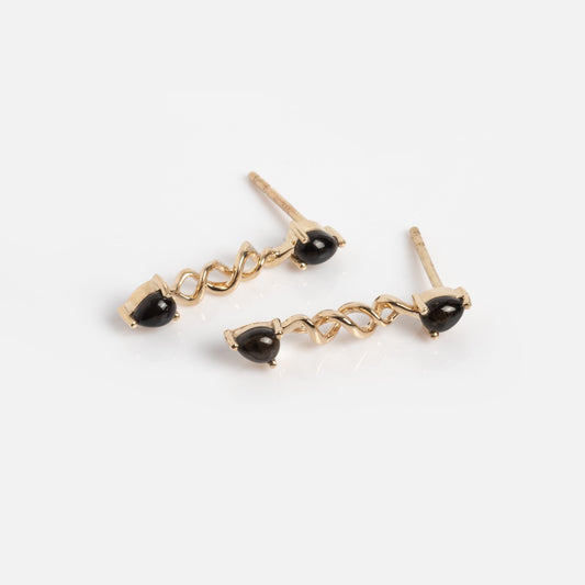 The Solid Gold Black Obsidian Earrings Sample are 9k solid gold stud earrings with twisted metal designs and Black Obsidian accents at the ends, shown on a white background.
