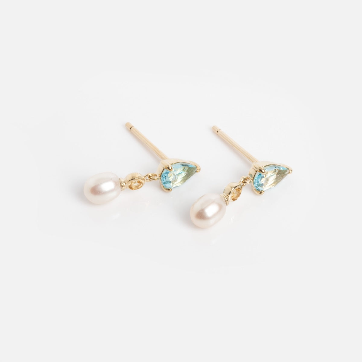 A pair of solid gold Blue Topaz, Citrine, and Pearl drop earrings—each featuring gemstones and pearls—displayed on a white background.