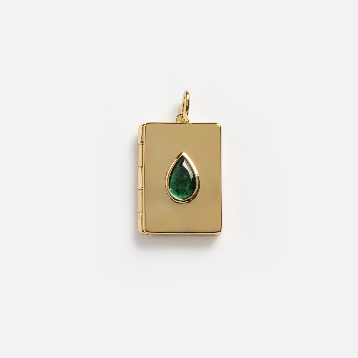 The Secret Gem Locket Charm Sample is a gold book-shaped locket with a left hinge and a teardrop green gemstone in the center, shown against a plain white background.