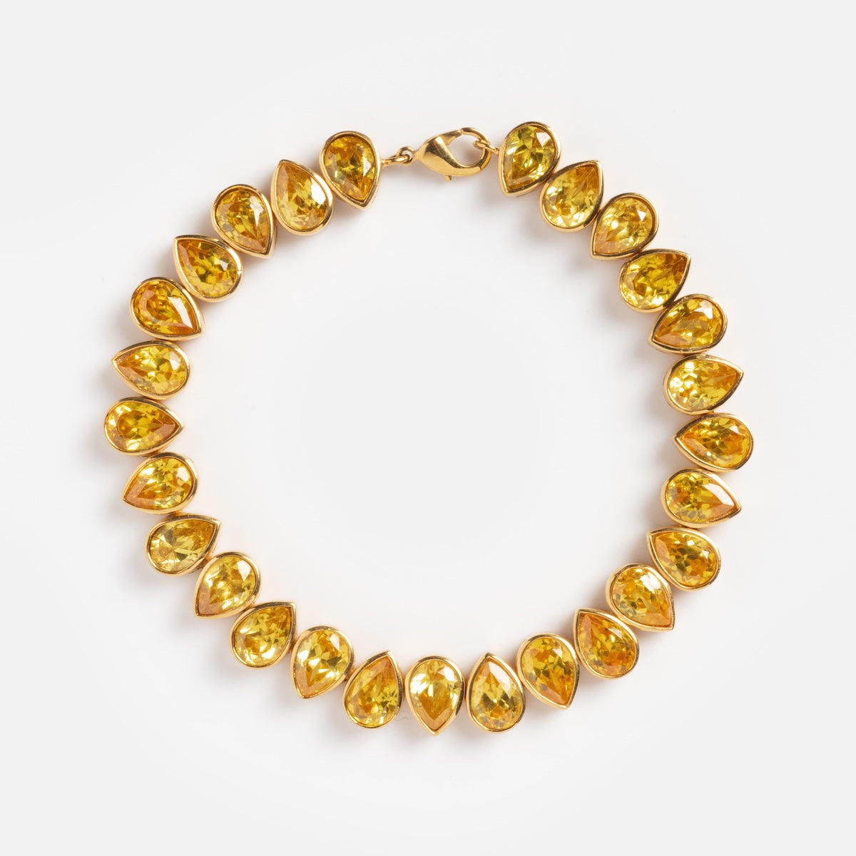 The Bezel Set Birthstone Tennis Bracelet November Sample features bezel-set yellow gemstones in a classic tennis style, showcased on a white background.