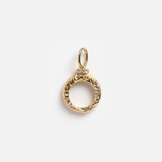 The Solid Gold Textured Round Charm Clip Sample features intricate engraving and a small top loop for attaching to a chain, shown on a plain white background.