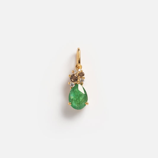 The Emerald Cluster Charm Sample is a gold pendant with a teardrop green gemstone and two small round white stones above it, shown on a plain white background.