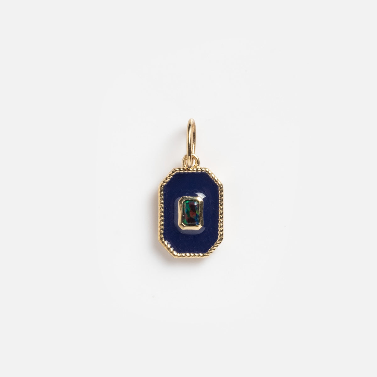 The Solid Gold Deco Black Opal Charm Sample features a rectangular gold pendant with a dark blue-black opal center, accented by a small multi-colored gemstone and finished with a gold border and top loop for attaching to a chain.