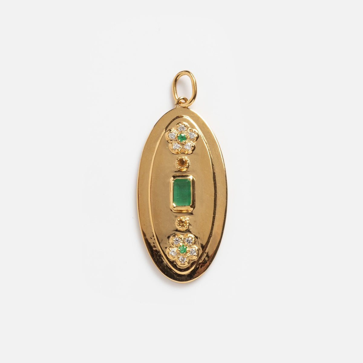 The Emerald Ctrine and White CZ Vintage Inspired Charm features a gold oval pendant with a rectangular green gemstone at the center and two round clusters above and below, each adorned with small clear stones.
