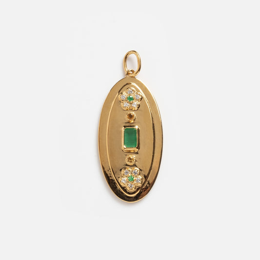 The Emerald Ctrine and White CZ Vintage Inspired Charm features a gold oval pendant with a rectangular green gemstone at the center and two round clusters above and below, each adorned with small clear stones.