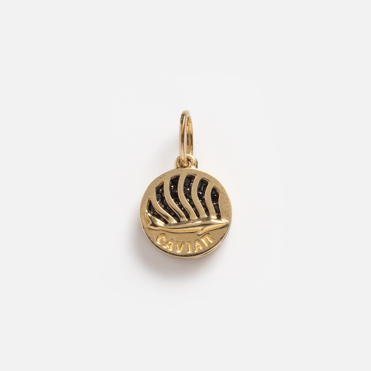 The Solid Gold Caviar Charm Sample is a round 9k gold charm with a raised boat and wave design, "CAVIAR" engraved at the bottom, shown on a plain white background.
