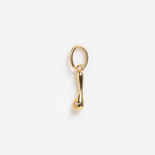 The Solid Gold Wavy Monogram Charm 'I' Sample is a small, gold pendant with an elongated, subtly curved drop shape and a circular loop, featuring a tiny gemstone near the rounded end, shown on a plain white background.