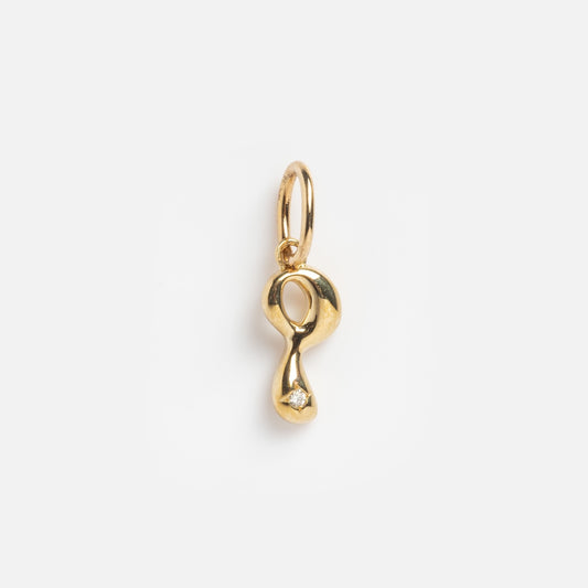 A Solid Gold Wavy Monogram Charm 'P' Sample with an abstract shape, smooth finish, oval top loop, and a clear stone near the bottom is shown against a plain white background.