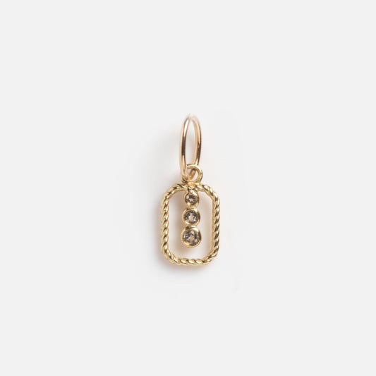 The Solid Gold Floating Topaz Drop Trio Charm Sample features a twisted rectangular gold frame with three vertically set round topaz gems, displayed against a plain white background.